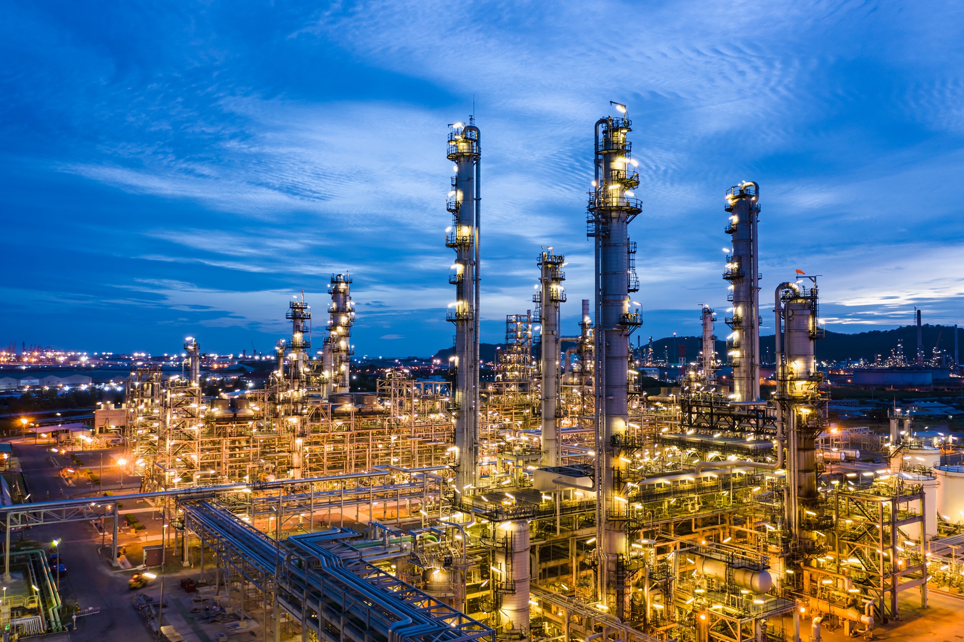 industrial oil and gas LPG refinery industry and commercial storage facilities import and export international by sea transport vessels aerial view at night in Thailand